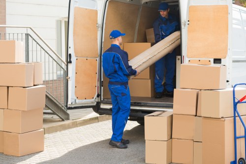 Removal van and moving team outside a Mitcham flat building