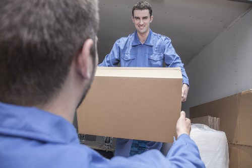 Packed moving boxes and furniture ready for transport in Mitcham