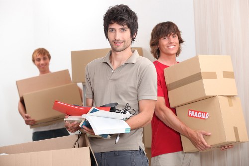 House removal van and movers working in a Mitcham residential street