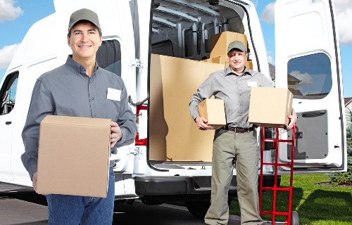 Loading household items into a van during a moving service