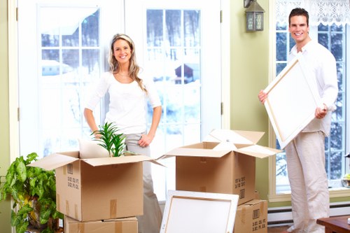 Local moving team transporting boxes and furniture in South London